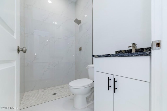 full bathroom with toilet, a tile shower, marble finish floor, and vanity