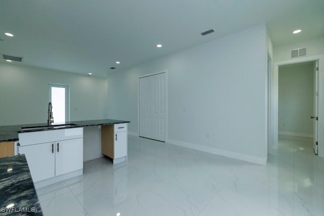 kitchen with marble finish floor, a sink, visible vents, and recessed lighting