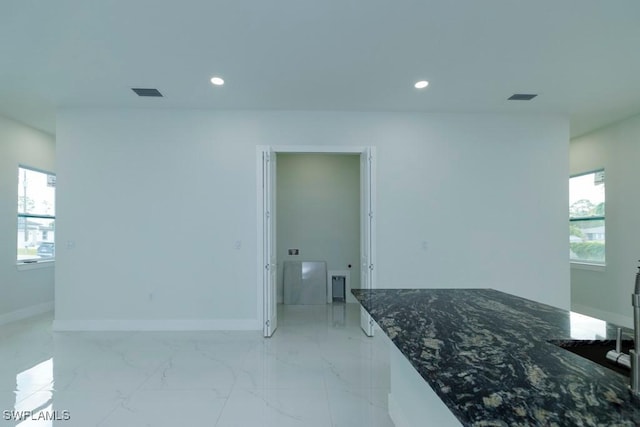 interior space featuring visible vents, baseboards, recessed lighting, and marble finish floor