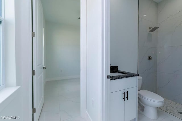 full bath featuring a marble finish shower, toilet, marble finish floor, and vanity