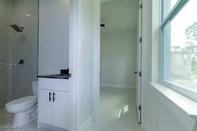full bathroom with a marble finish shower, toilet, marble finish floor, and vanity