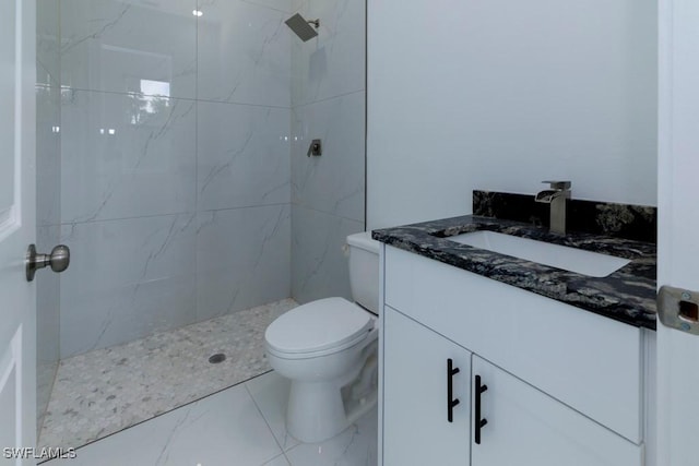bathroom featuring toilet, vanity, marble finish floor, and a marble finish shower