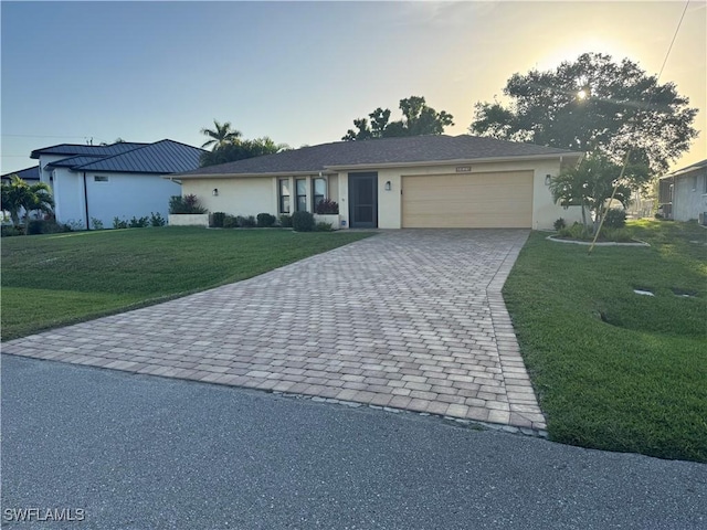 4628 SW 18th Ave, Cape Coral, FL 33914 - ranch-style house featuring a garage, decorative driveway, stucco siding, and a front lawn