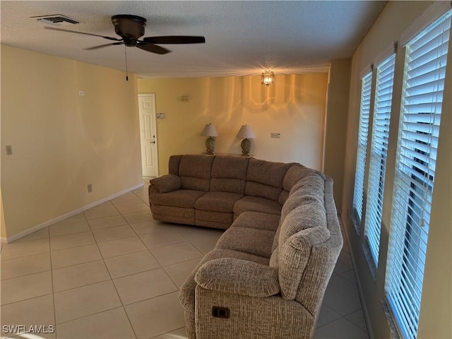 4628 SW 18th Ave, Cape Coral, FL 33914 - living room with light tile patterned floors, baseboards, a textured ceiling, visible vents, and a ceiling fan