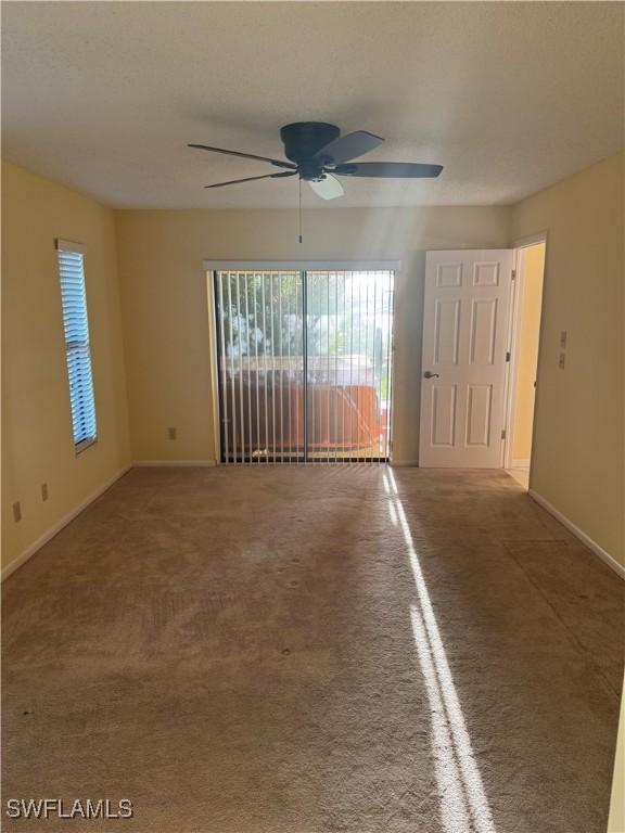 4628 SW 18th Ave, Cape Coral, FL 33914 - unfurnished room featuring baseboards, ceiling fan, and carpet