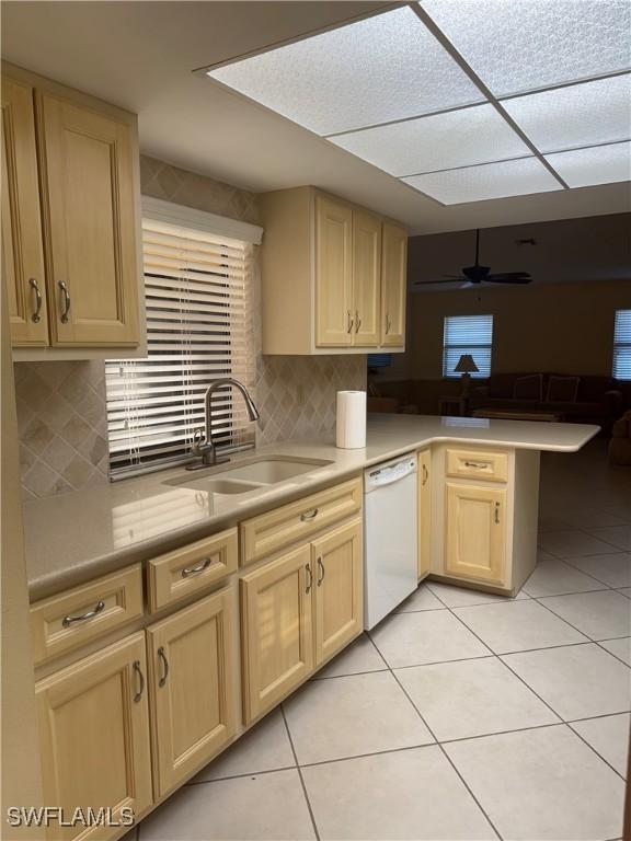 4628 SW 18th Ave, Cape Coral, FL 33914 - kitchen with light brown cabinets, a sink, a peninsula, white dishwasher, and light tile patterned floors