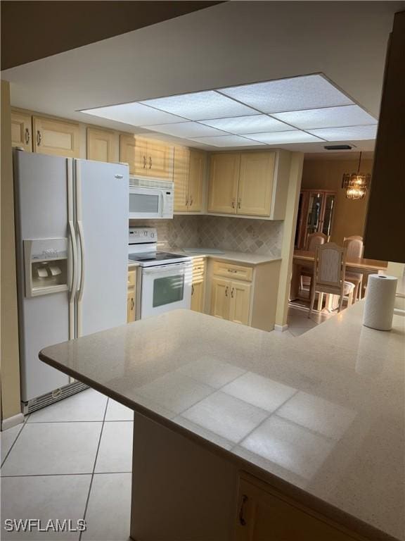 4628 SW 18th Ave, Cape Coral, FL 33914 - kitchen featuring light countertops, tasteful backsplash, white appliances, light tile patterned floors, and light brown cabinetry