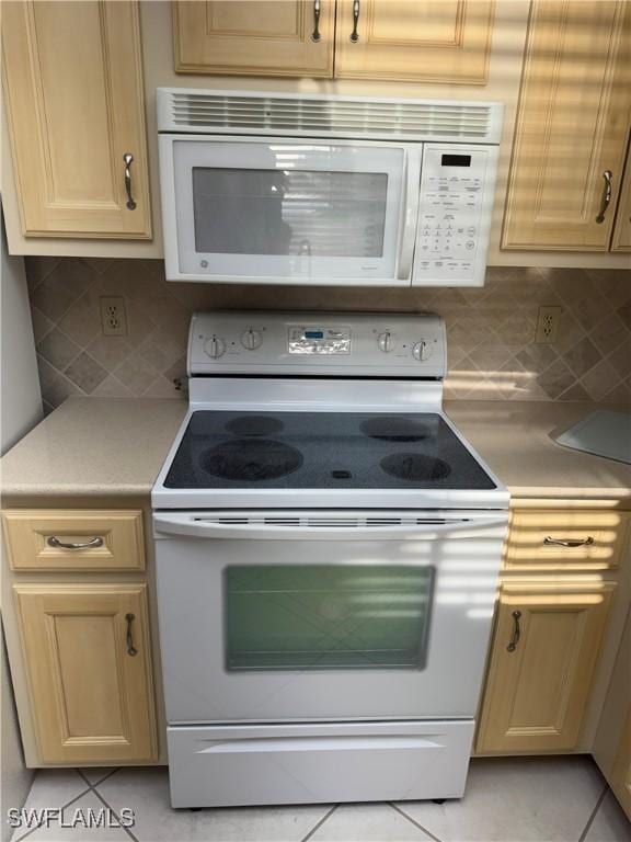 4628 SW 18th Ave, Cape Coral, FL 33914 - kitchen featuring light brown cabinets, light countertops, backsplash, and white appliances