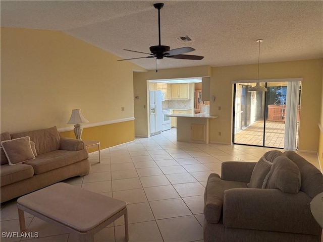 4628 SW 18th Ave, Cape Coral, FL 33914 - living area with a ceiling fan, a textured ceiling, lofted ceiling, light tile patterned floors, and visible vents