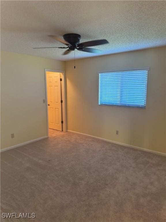 4628 SW 18th Ave, Cape Coral, FL 33914 - spare room with carpet floors, baseboards, ceiling fan, and a textured ceiling