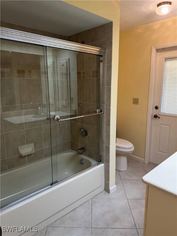 4628 SW 18th Ave, Cape Coral, FL 33914 - full bath with tile patterned flooring, vanity, toilet, baseboards, and enclosed tub / shower combo