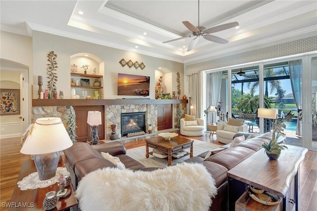 living area with crown molding, ceiling fan, arched walkways, recessed lighting, and wood finished floors
