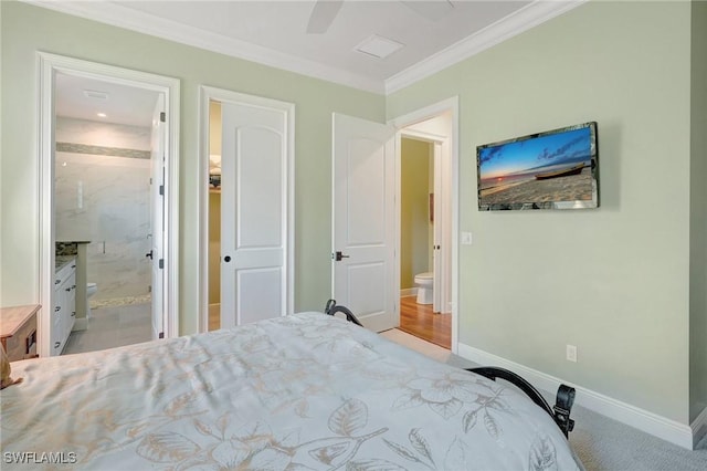 bedroom with crown molding, baseboards, a ceiling fan, and connected bathroom