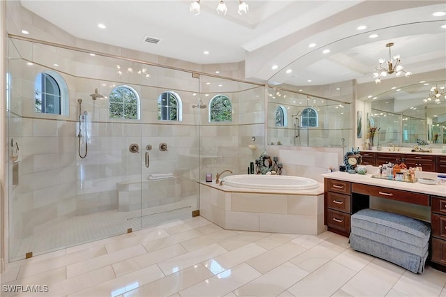 bathroom featuring vanity, a stall shower, a chandelier, tile patterned floors, and a bath