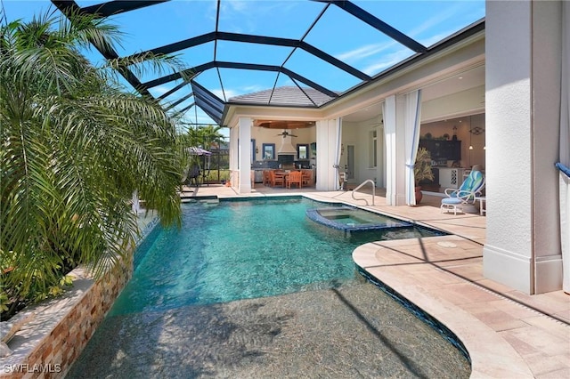 view of pool featuring a patio, a pool with connected hot tub, a ceiling fan, and glass enclosure