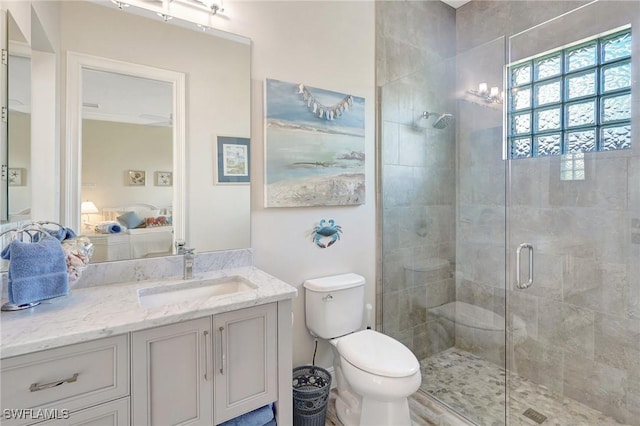 ensuite bathroom with a shower stall, vanity, toilet, and ensuite bathroom