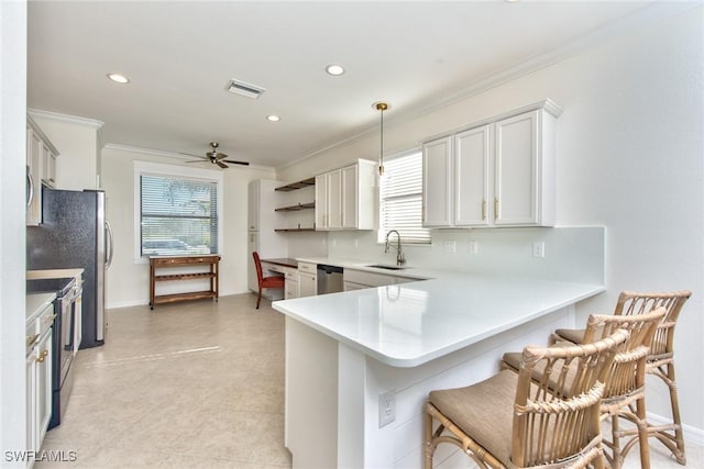 kitchen with light countertops, crown molding, stainless steel appliances, backsplash, and visible vents