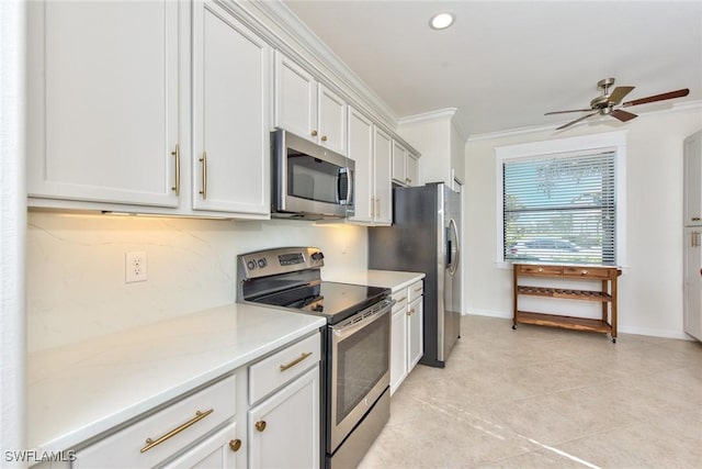 kitchen with light tile patterned flooring, light countertops, crown molding, stainless steel appliances, and a ceiling fan