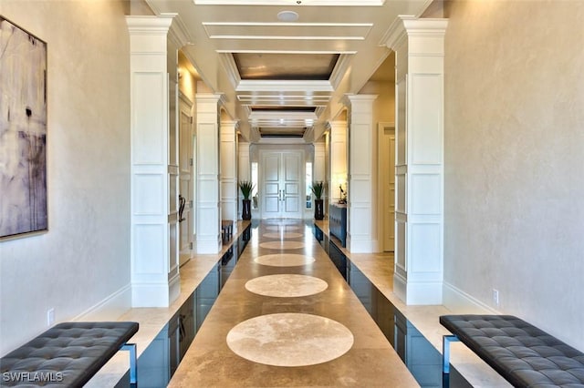 corridor featuring coffered ceiling, a decorative wall, beamed ceiling, ornamental molding, and ornate columns