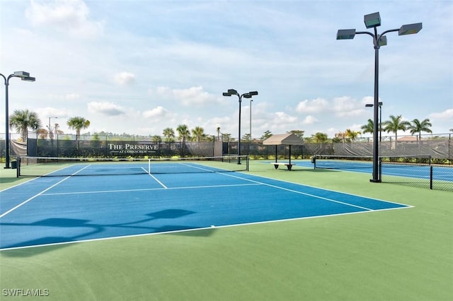 view of sport court featuring fence