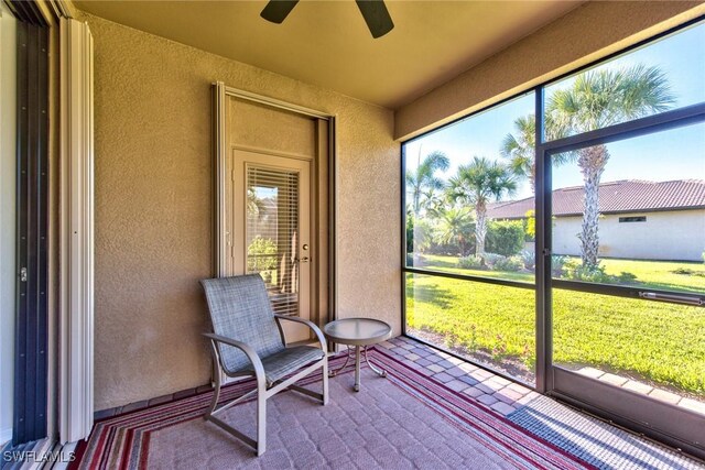 unfurnished sunroom with a ceiling fan