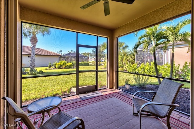 sunroom featuring ceiling fan