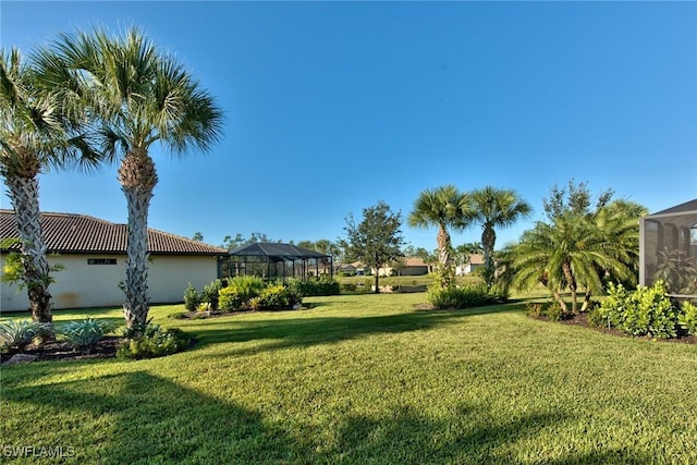 view of yard with a lanai