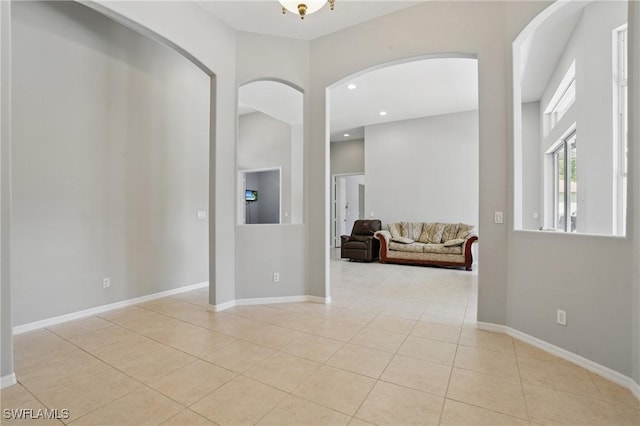 510 13th St NW, Naples, FL 34120 - entryway with baseboards, arched walkways, recessed lighting, and light tile patterned floors
