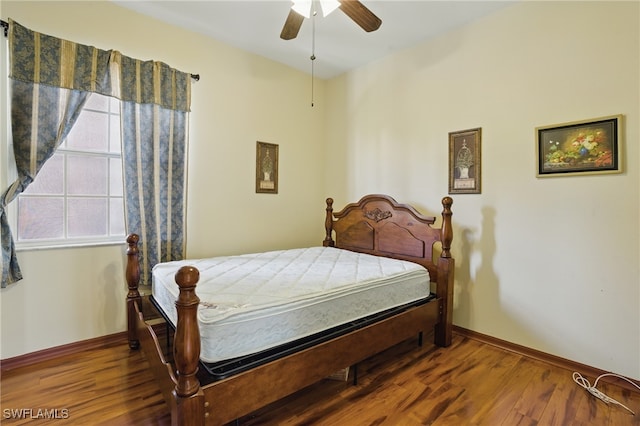 510 13th St NW, Naples, FL 34120 - bedroom with baseboards, wood finished floors, and a ceiling fan