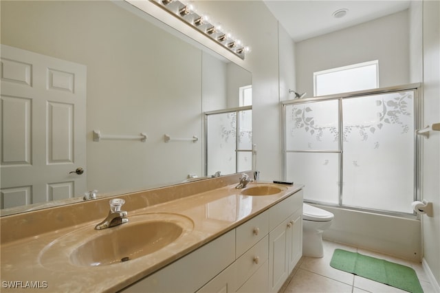 510 13th St NW, Naples, FL 34120 - full bathroom with double vanity, toilet, tile patterned flooring, and a sink