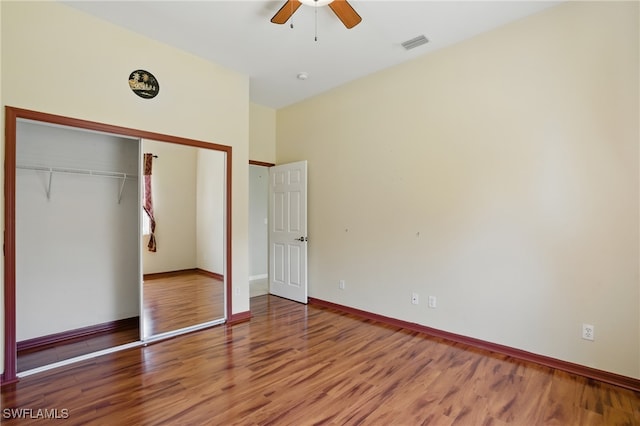 510 13th St NW, Naples, FL 34120 - unfurnished bedroom featuring a closet, visible vents, baseboards, wood finished floors, and a ceiling fan