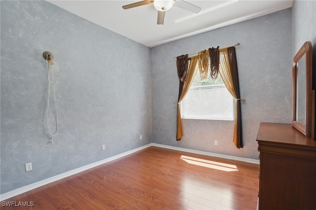 510 13th St NW, Naples, FL 34120 - spare room featuring baseboards, wood finished floors, and a ceiling fan