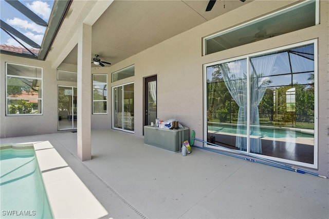510 13th St NW, Naples, FL 34120 - view of patio / terrace with glass enclosure, an outdoor pool, and ceiling fan