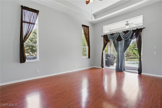 510 13th St NW, Naples, FL 34120 - unfurnished room featuring baseboards, ceiling fan, wood finished floors, and a tray ceiling