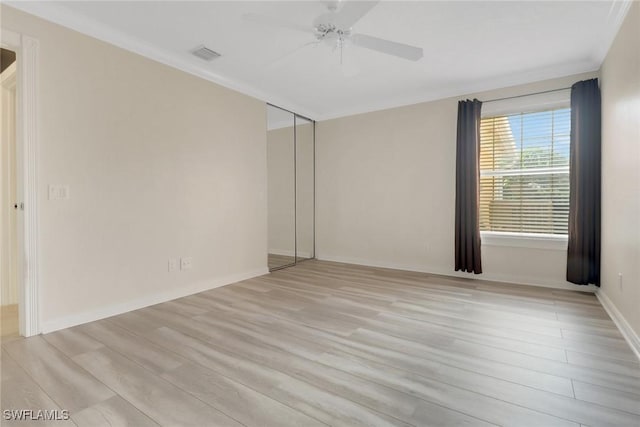 7933 Umberto Ct, Naples, FL 34114 - empty room with baseboards, visible vents, crown molding, and light wood finished floors