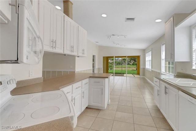 7933 Umberto Ct, Naples, FL 34114 - kitchen featuring white appliances, light tile patterned floors, a sink, visible vents, and white cabinets