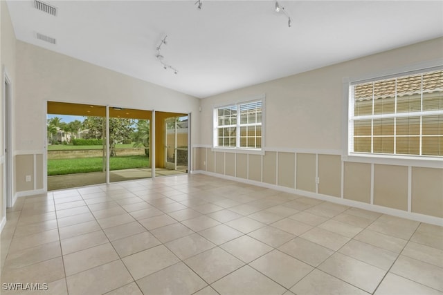 7933 Umberto Ct, Naples, FL 34114 - unfurnished room featuring light tile patterned flooring, lofted ceiling, visible vents, and track lighting