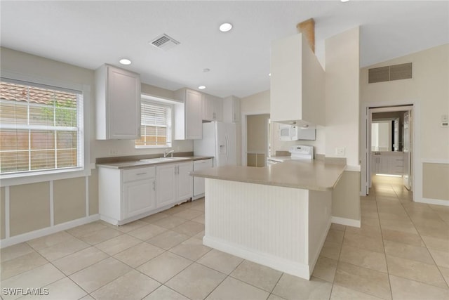 7933 Umberto Ct, Naples, FL 34114 - kitchen featuring light tile patterned floors, visible vents, a peninsula, and white appliances