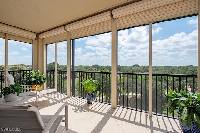 sunroom featuring tile patterned floors and a wealth of natural light