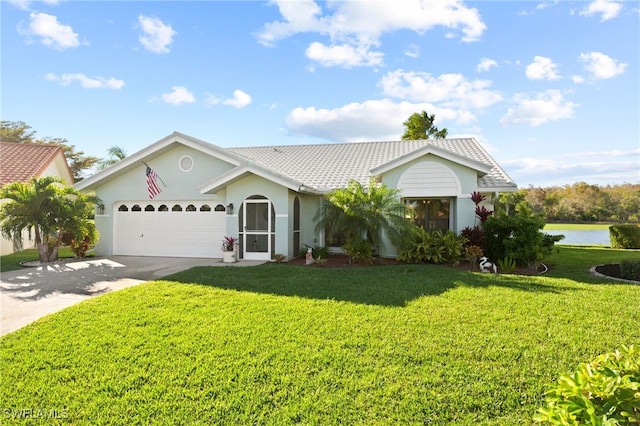 ranch-style house with driveway, stucco siding, an attached garage, and a front lawn