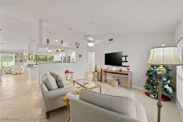living area with lofted ceiling, light tile patterned floors, and a ceiling fan