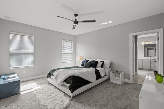 1338 Kendari Ter, Naples, FL 34113 - bedroom with ceiling fan, light colored carpet, baseboards, and connected bathroom