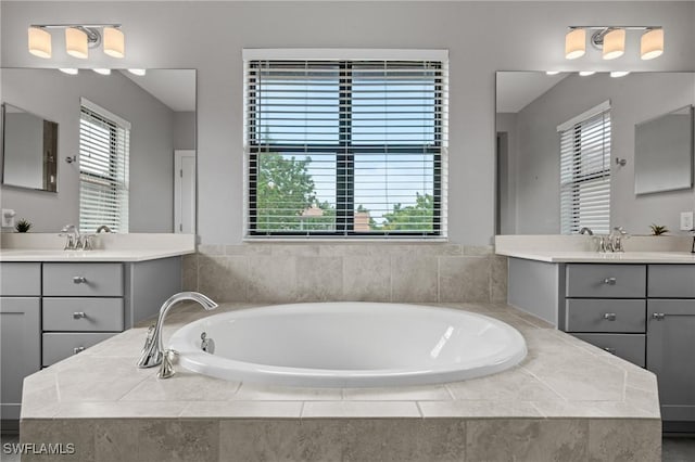 1338 Kendari Ter, Naples, FL 34113 - full bath featuring two vanities, a bath, and a sink