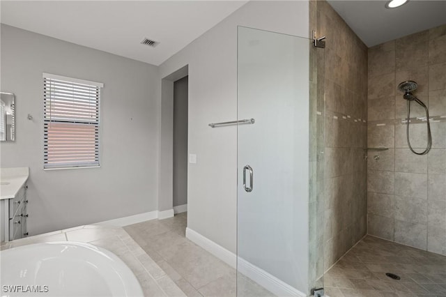 1338 Kendari Ter, Naples, FL 34113 - full bath featuring visible vents, a tub, vanity, tile patterned floors, and a stall shower