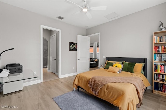 1338 Kendari Ter, Naples, FL 34113 - bedroom featuring visible vents, baseboards, ceiling fan, ensuite bath, and wood finished floors