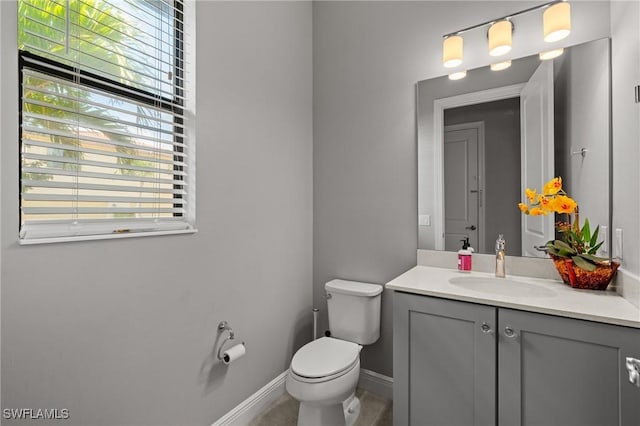 1338 Kendari Ter, Naples, FL 34113 - bathroom featuring plenty of natural light, vanity, baseboards, and toilet