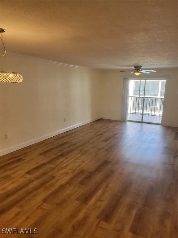 unfurnished room featuring baseboards, wood finished floors, and a ceiling fan