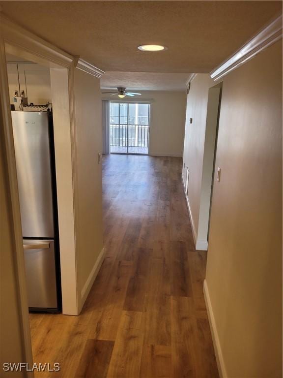 hallway with light wood finished floors and baseboards