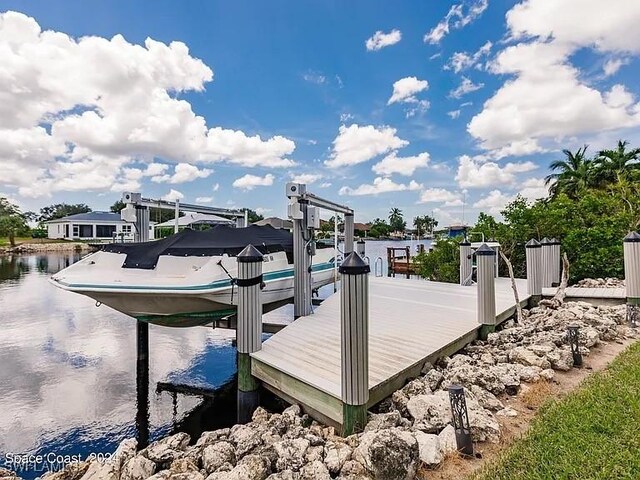 162 Windward Cay, Naples, FL 34114 - view of dock featuring boat lift and a water view