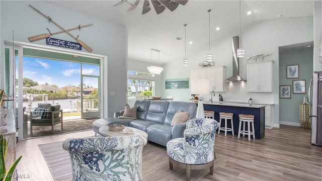 162 Windward Cay, Naples, FL 34114 - living area with high vaulted ceiling, light wood-type flooring, and baseboards